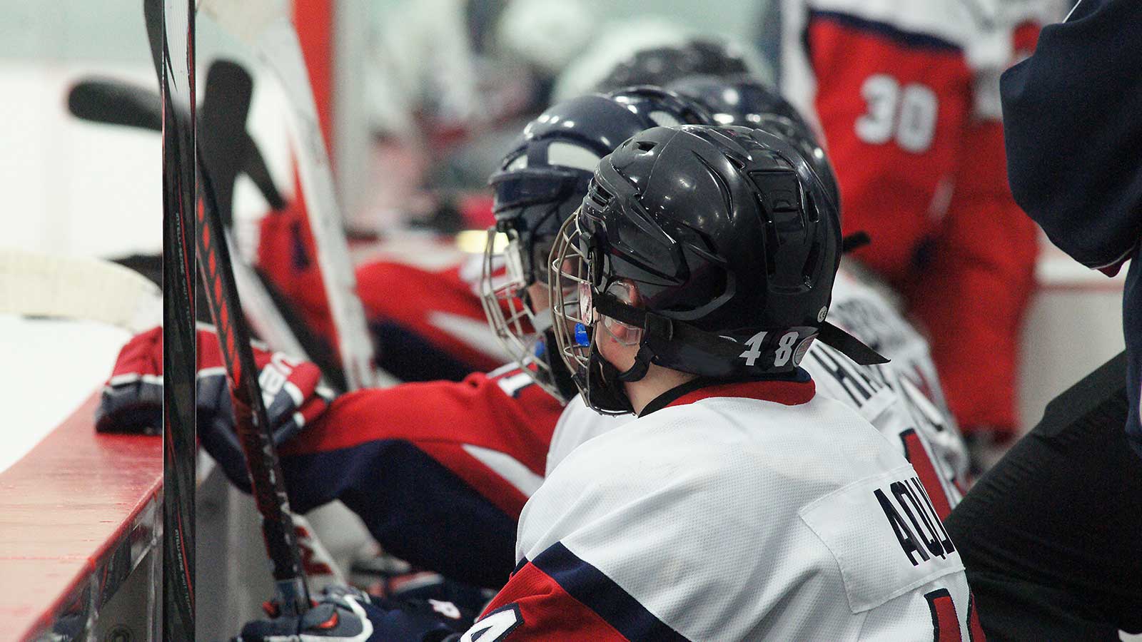 Players on the bench at a bantam hockey tryout Players on the bench at a bantam hockey tryout